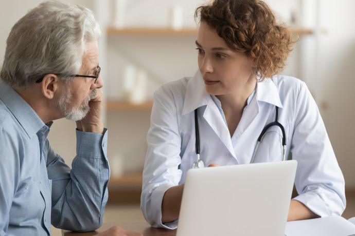 Médico habla con paciente de síntomas del Parkinson