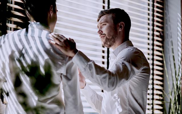 Man consoling a coworker at work